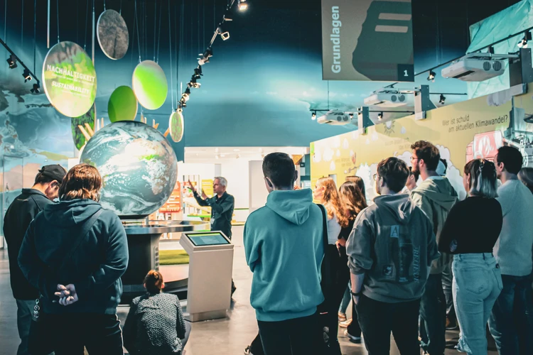 Gruppe bei F&uuml;hrung am interaktiven Globus in der KLIMA ARENA.